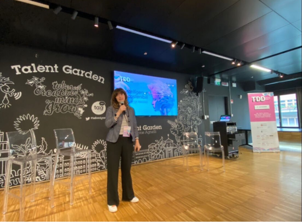 Isabella Brusati speaking at Talent Garden Digital Days, holding a microphone on stage.
